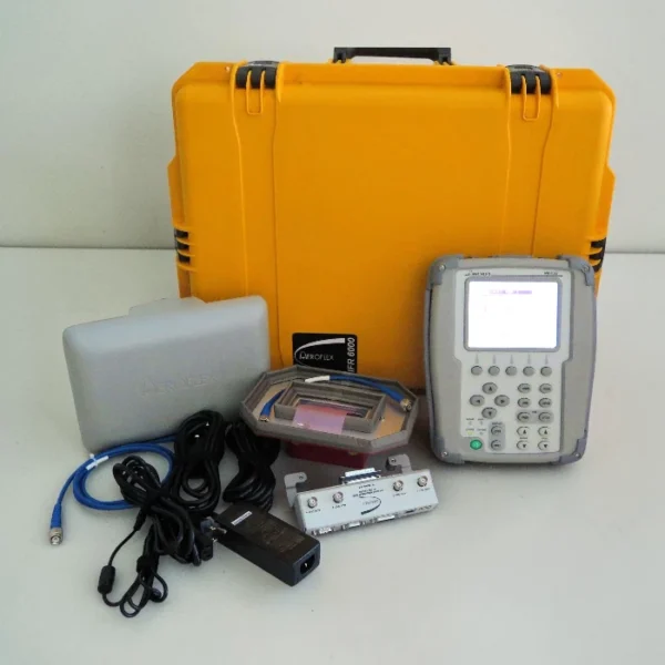 The complete Aeroflex IFR 6000 Transponder TCAS Test Set kit laid out with the handheld unit, directional antenna, connection cables, power adapter, and a large yellow protective transit case.