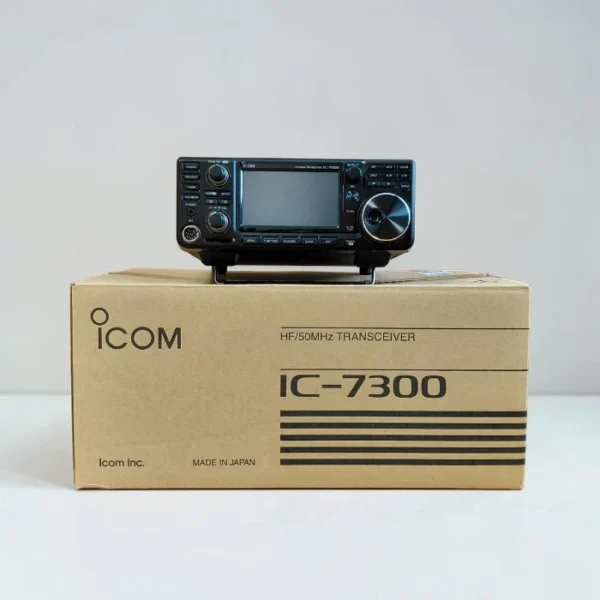 Icom IC-7300 HF/50MHz Transceiver radio unit placed on top of its original cardboard packaging box featuring the Icom logo.