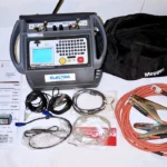 Megger DLRO 200-115 Digital Low Resistance Ohmmeter unit complete with heavy-duty test leads, communication cables, manuals, and a branded carry bag.